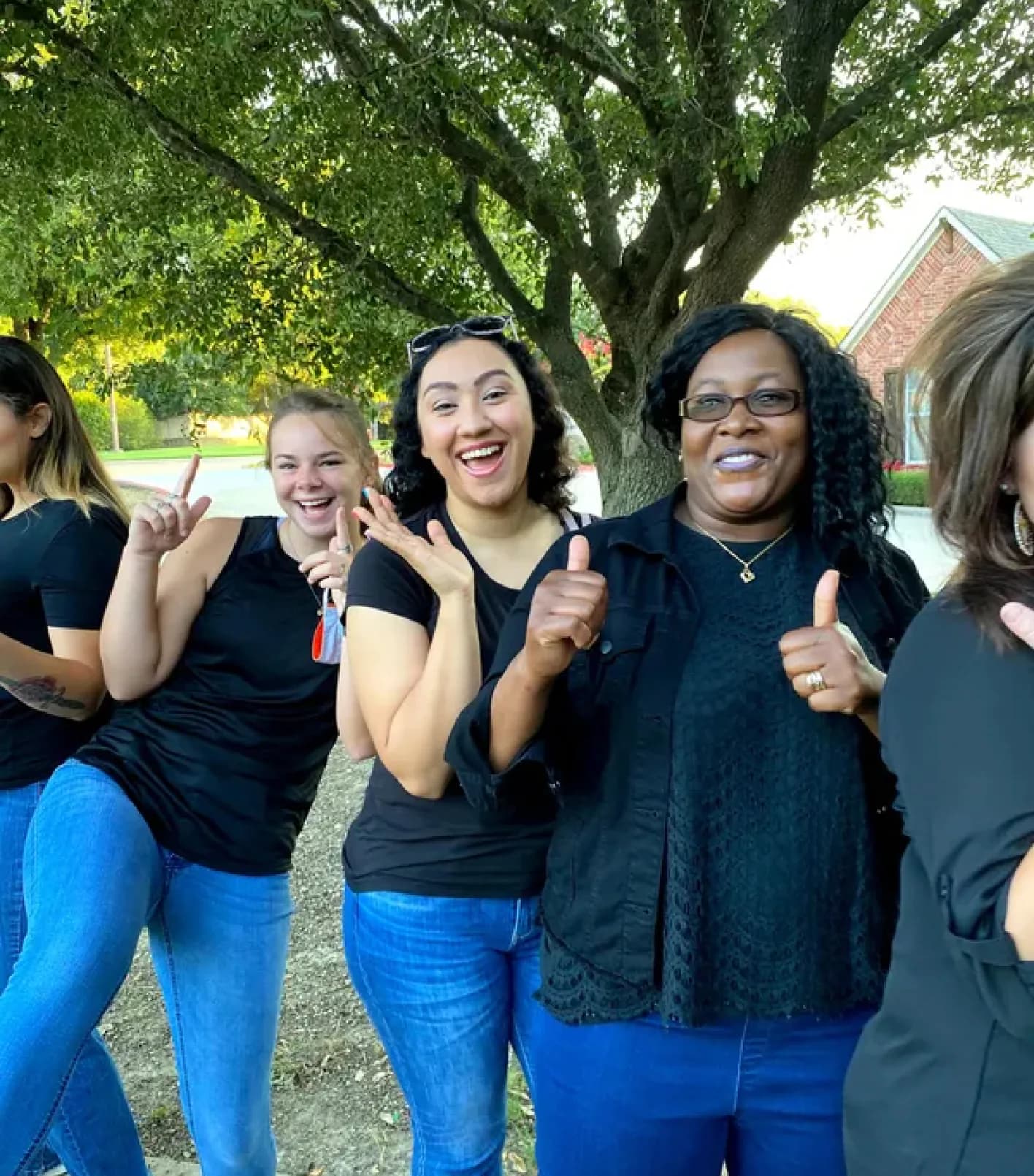 Ladies in uniform with blue jeans and dark tops