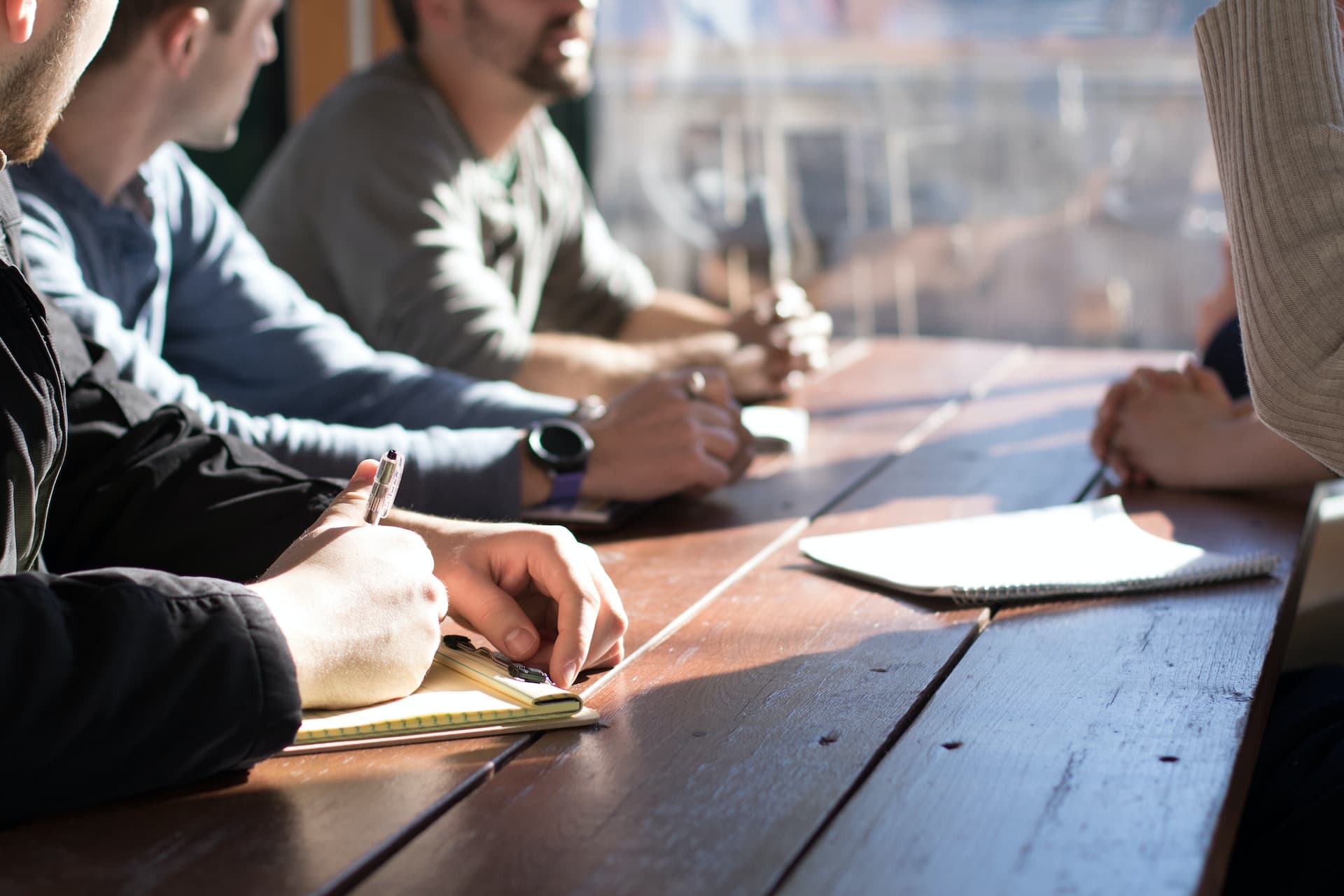 People around a table having a discussion or a training session.