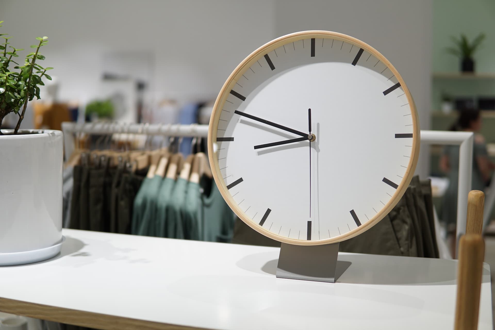 A clock on a table in a store.