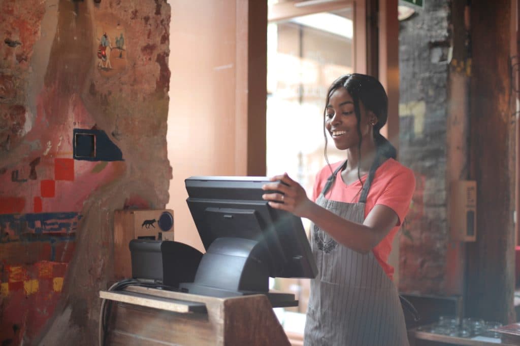 Employee at a restaurant working the cashier
