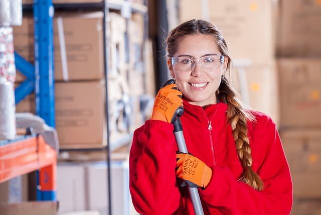 Girl in a warehouse smiling for a picture