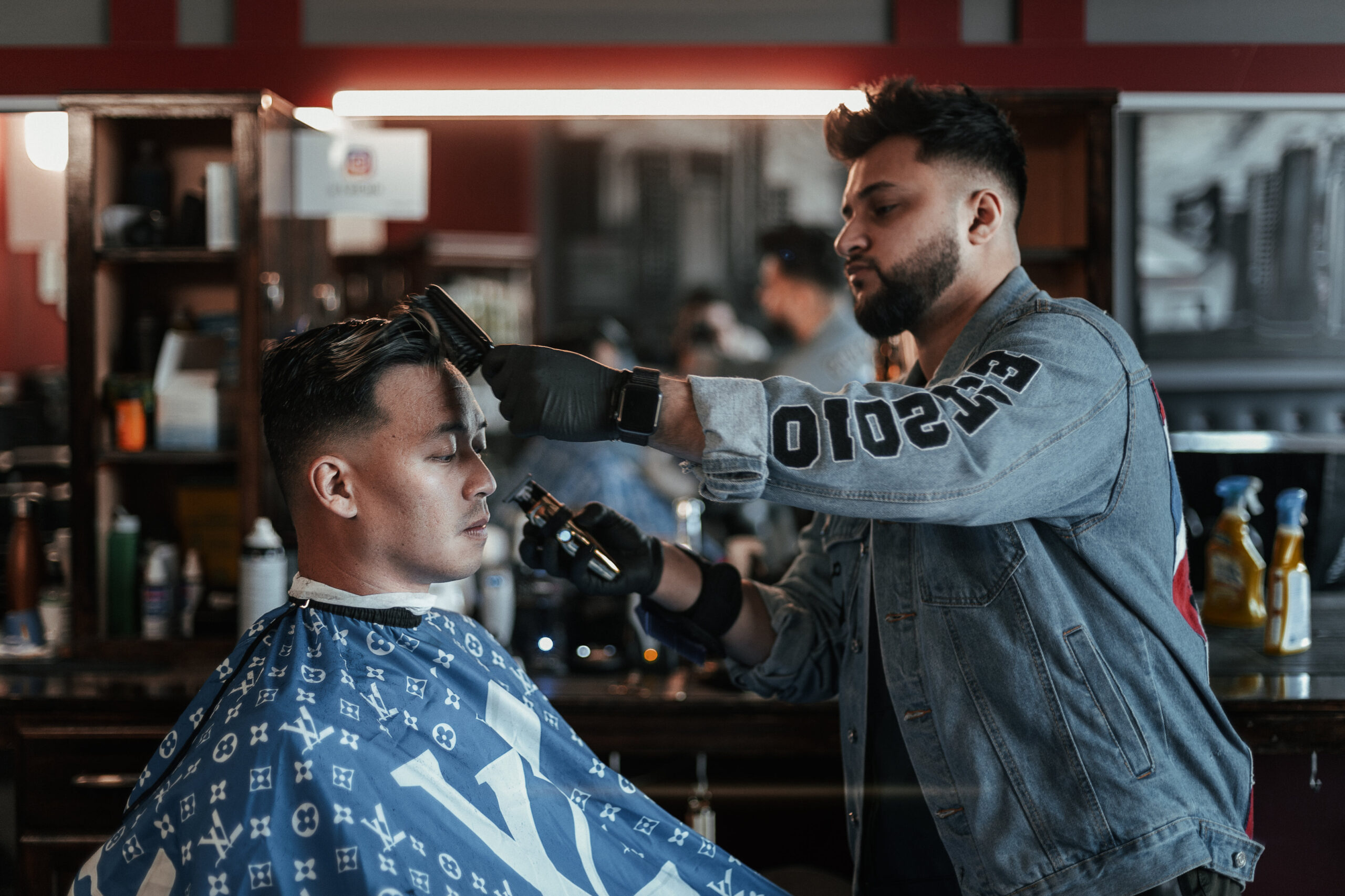 barber brushes and cuts hair scaled