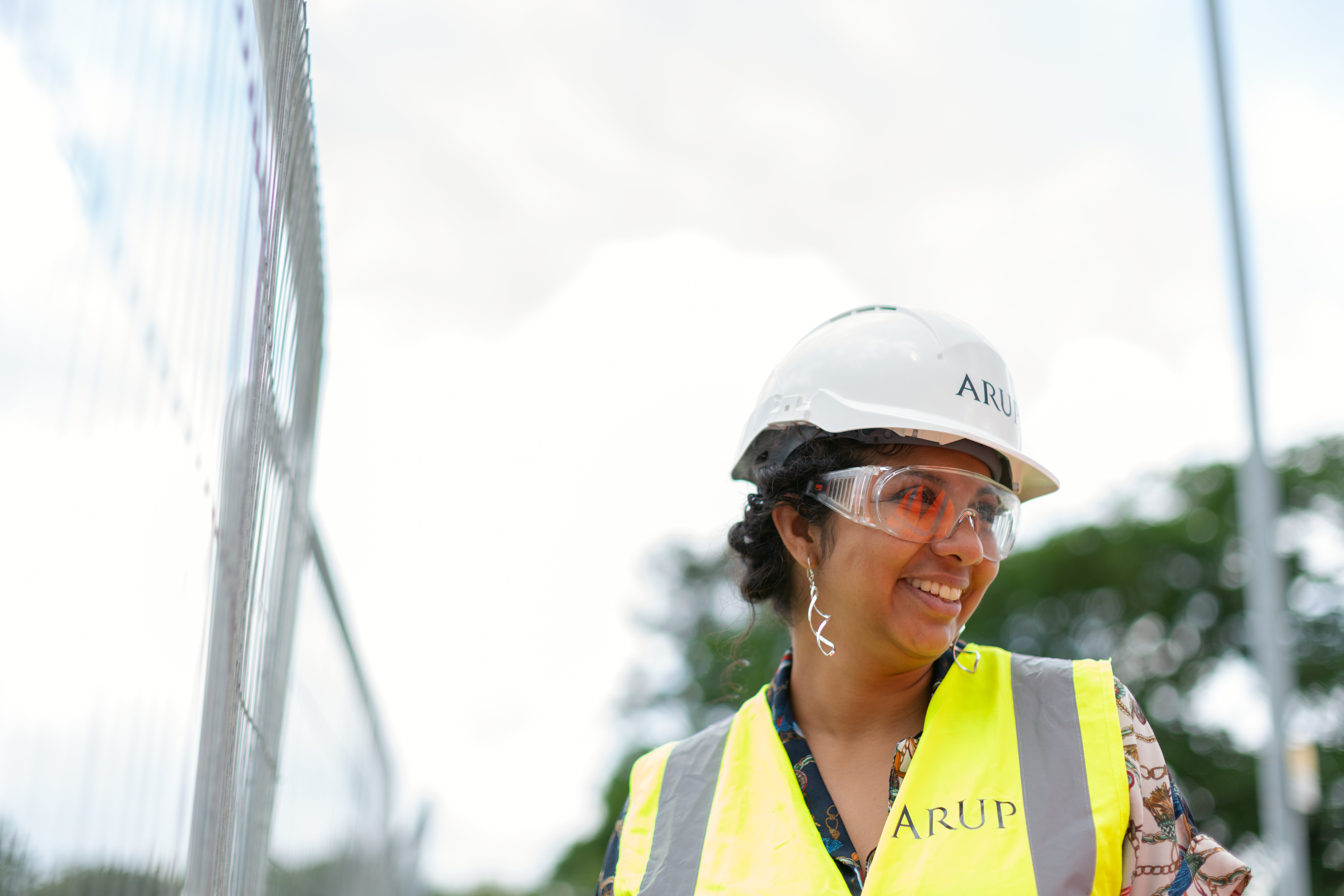 Woman wearing hard hat and yellow vest